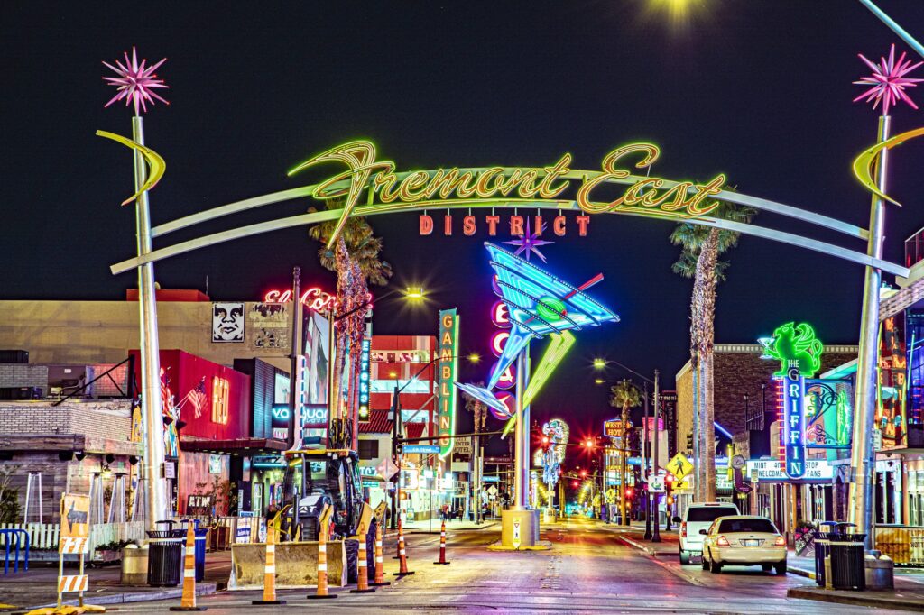 Illuminated Fremont East District arch above a street with neon signs at night