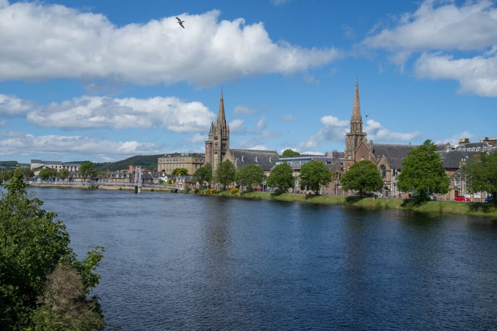 Buildings and a church beside the River Ness in Inverness