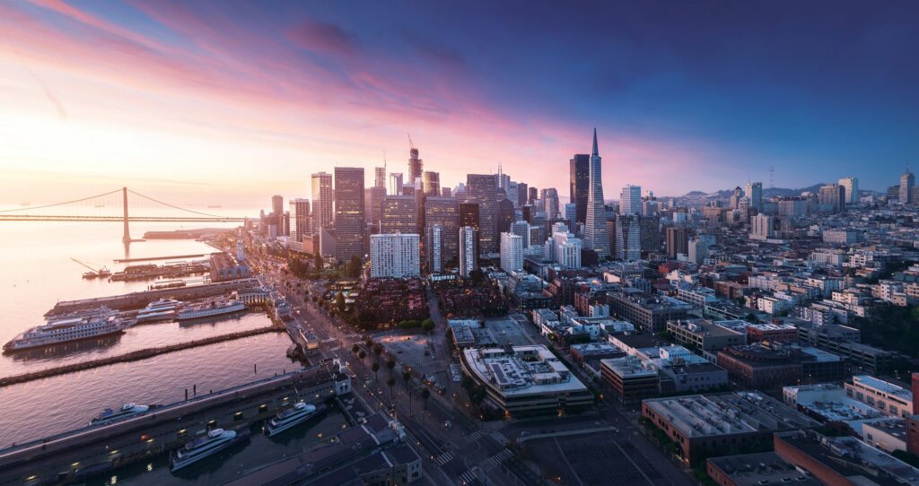Aerial view of the Financial District, waterfront and piers at sunset