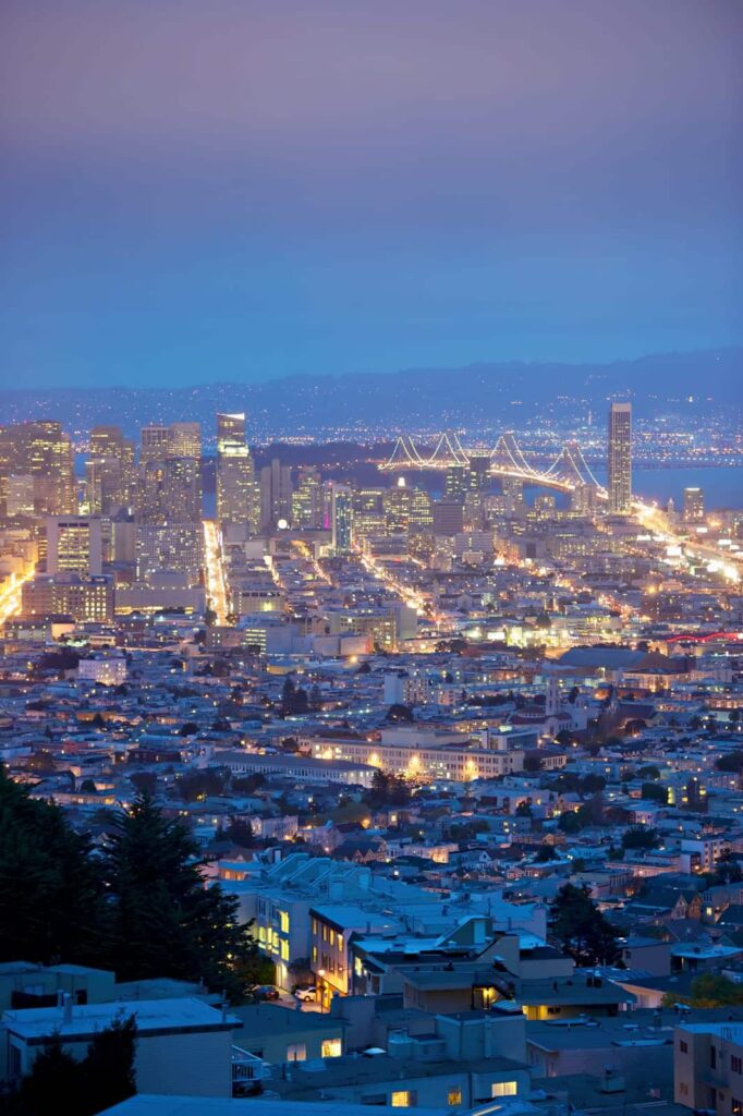 View over San Francisco streets and buildings lighting up at dusk