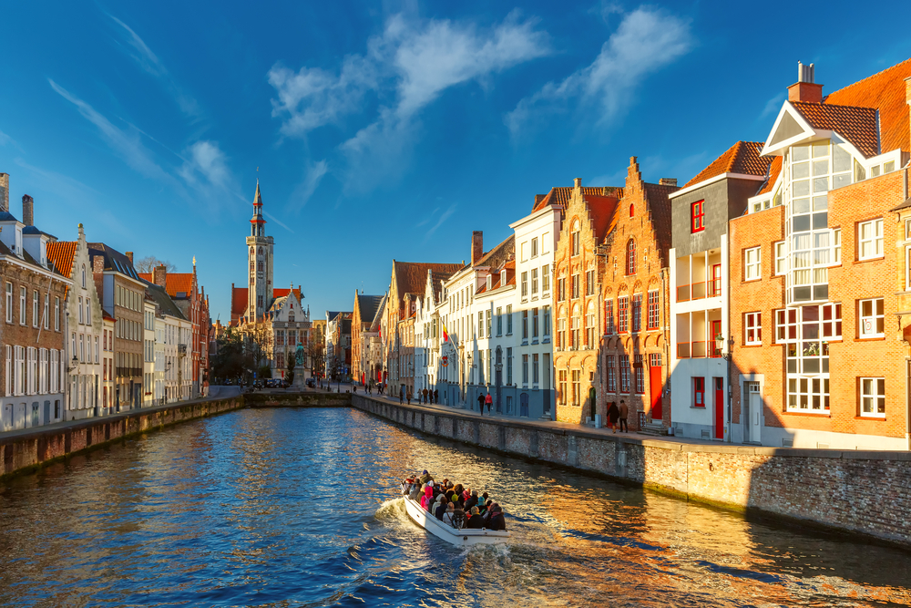 Where to Stay in Bruges? The 5 Best Areas & Places to Stay 9 A canal boat on Spiegelrei by Jan van Eyckplein in Bruges