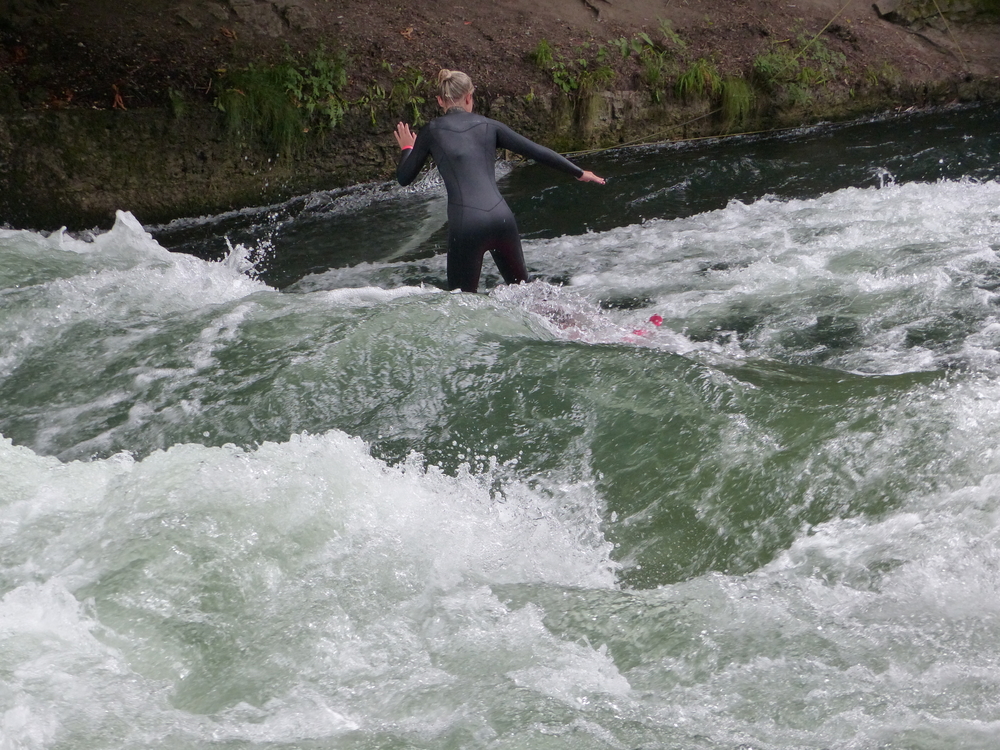 18 Best Things to Do in Munich: Sights, Prices & Tips 24 A surfer on the Eisbach wave by the Englischer Garten in Munich