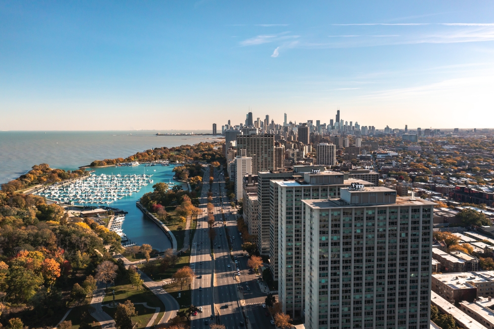 Aerial view of Lakeview and Belmont Harbor with the Chicago skyline in the background