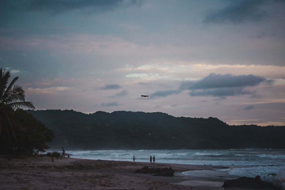 Aerial view of the long sandy beach at Playa Carmen in Santa Teresa at sunset
