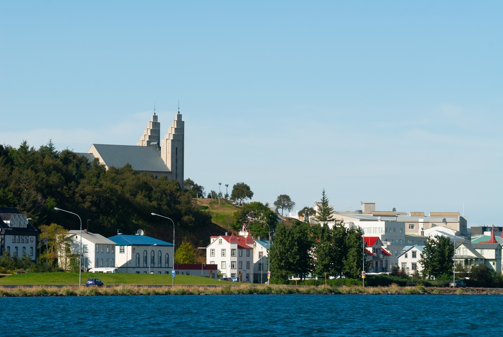 Akureyri seen across the Eyjafjörður fjord with colourful houses along the water and the church above the town