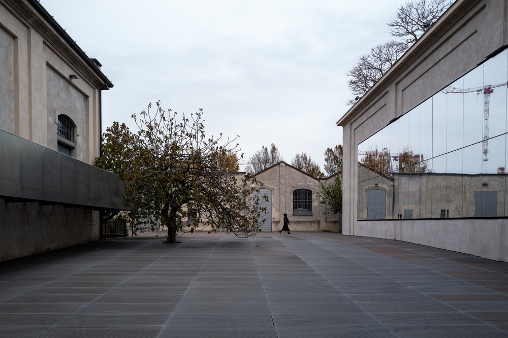 Fondazione Prada in Milan with its tower reflected in water