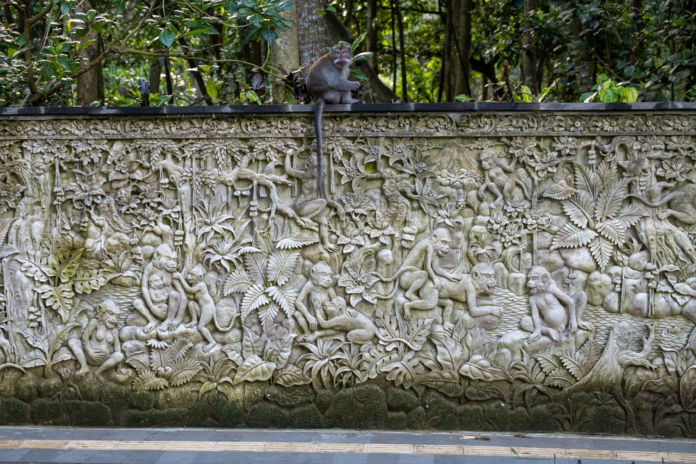 Macaque on a stone relief in Ubud Monkey Forest