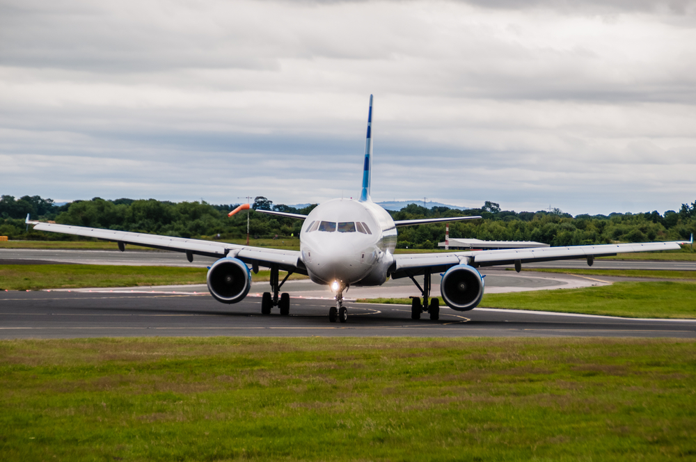 A plane landing at Manchester Airport
