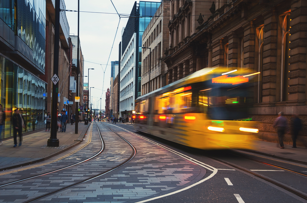 A Metrolink tram in Manchester city centre in the evening