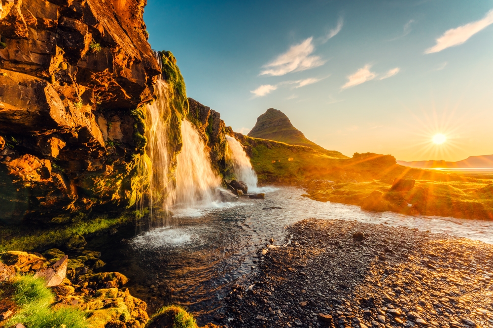 Mount Kirkjufell and the Kirkjufellsfoss waterfall on Snæfellsnes at sunrise