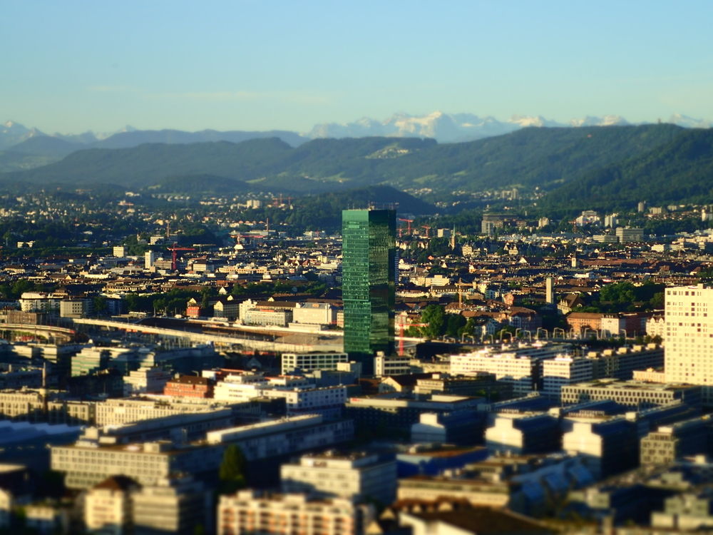 Prime Tower in Zurich West at sunrise with the Alps in the background
