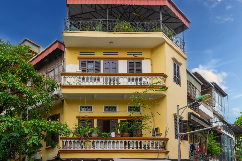 Tall, narrow townhouses with plants on the facade in the Old Quarter in Hanoi