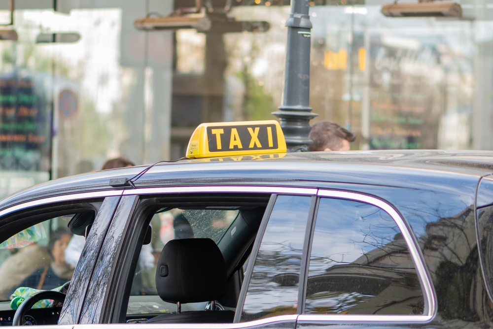 Taxi with a yellow sign on a street in Vienna