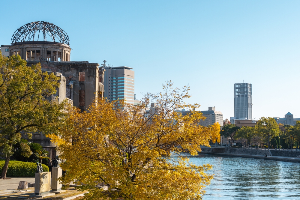 Where to Stay in Japan? The 7 Best Areas & Places to Stay 16 The Atomic Bomb Dome by the Motoyasu River in the Peace Memorial Park in Hiroshima in autumn