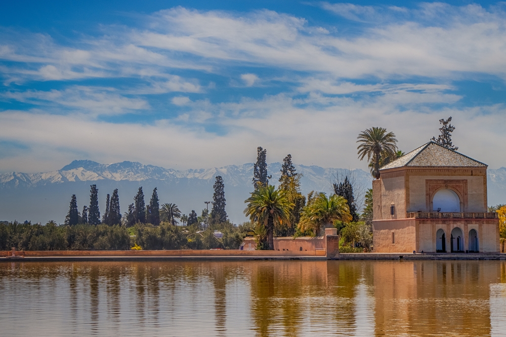 The Menara Gardens in Marrakech with the pavilion and Atlas Mountains in the background