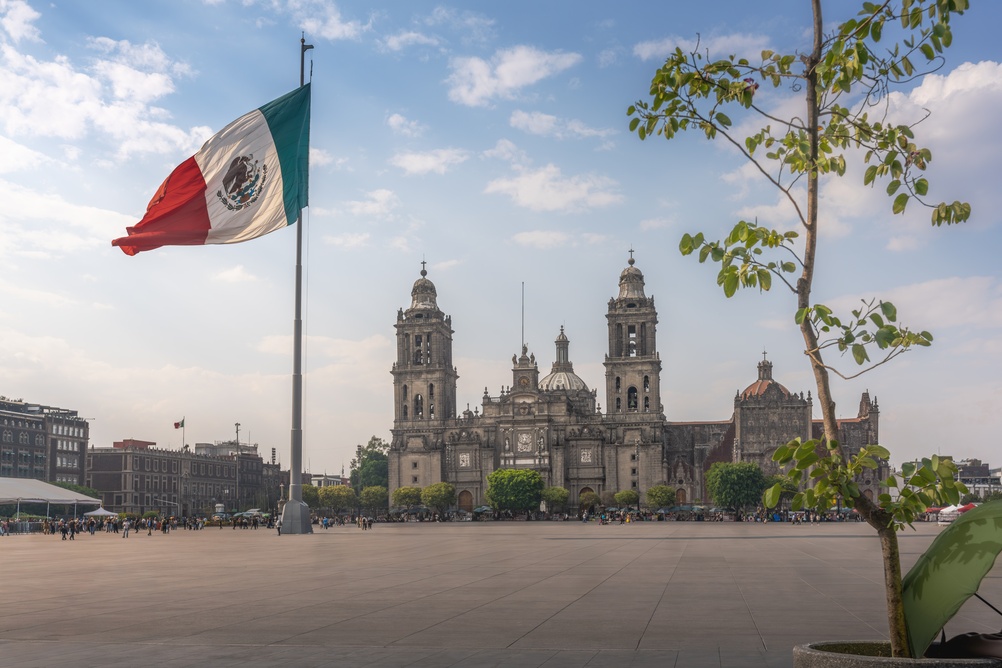 The Zócalo with the Mexican flag and the cathedral in Centro Histórico in Mexico City