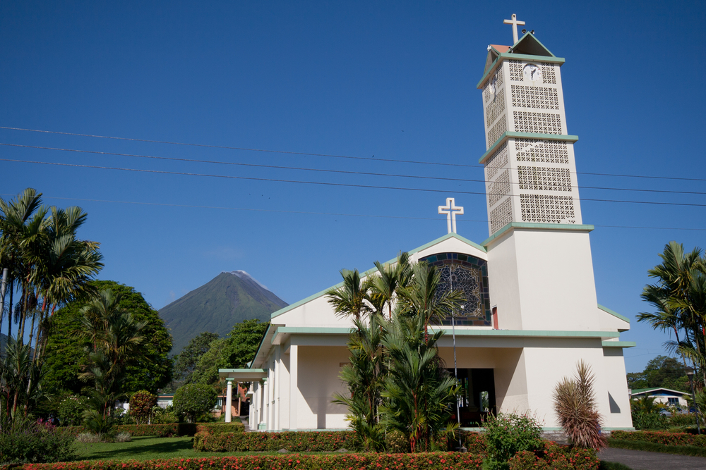 The church and park in La Fortuna with Arenal Volcano in the background