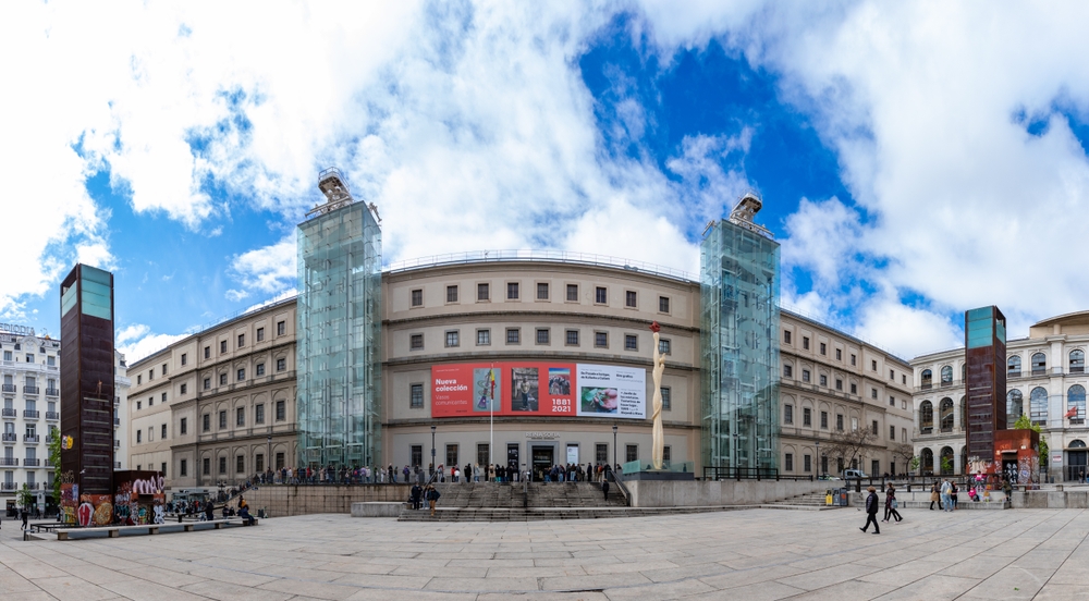 18 Best Things to Do in Madrid: Sights, Prices & Tips 24 The main facade of the Museo Reina Sofía in Madrid with visitors queuing at the entrance