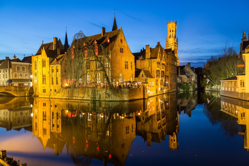 The Rozenhoedkaai and the Belfry in Bruges at dusk