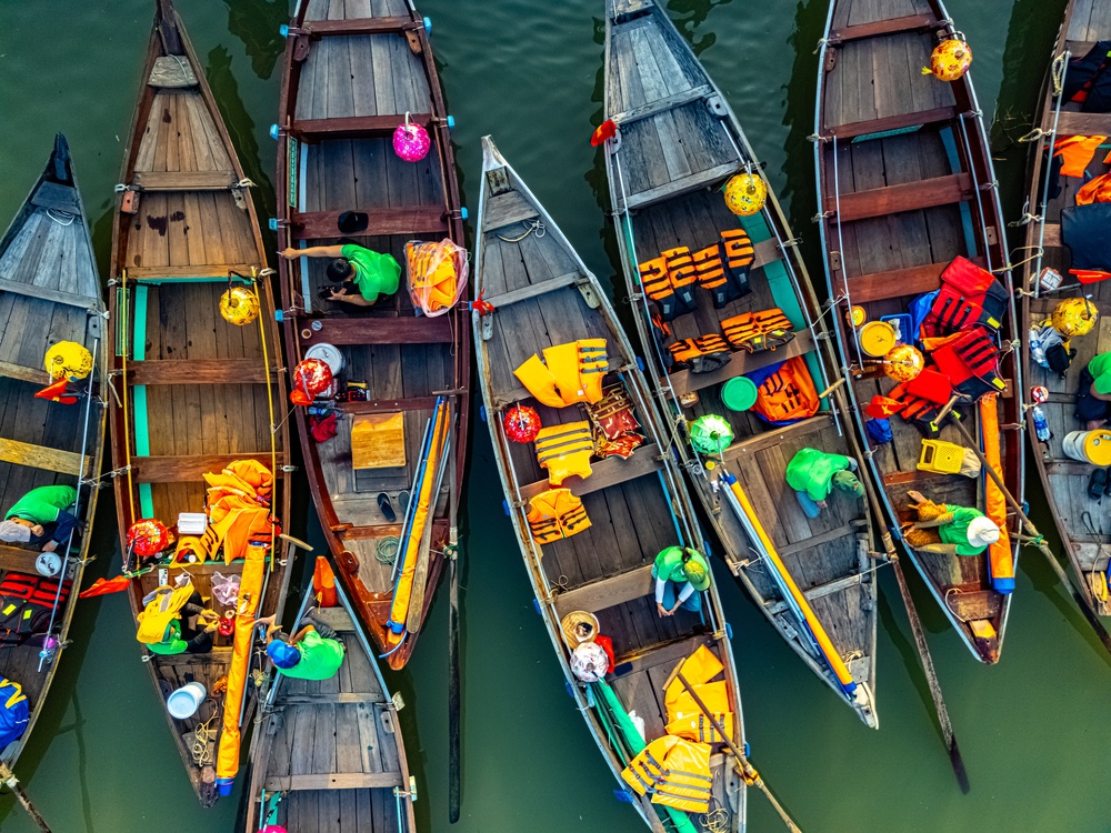 Wooden boats on the Thu Bon River by the Old Town in Hoi An