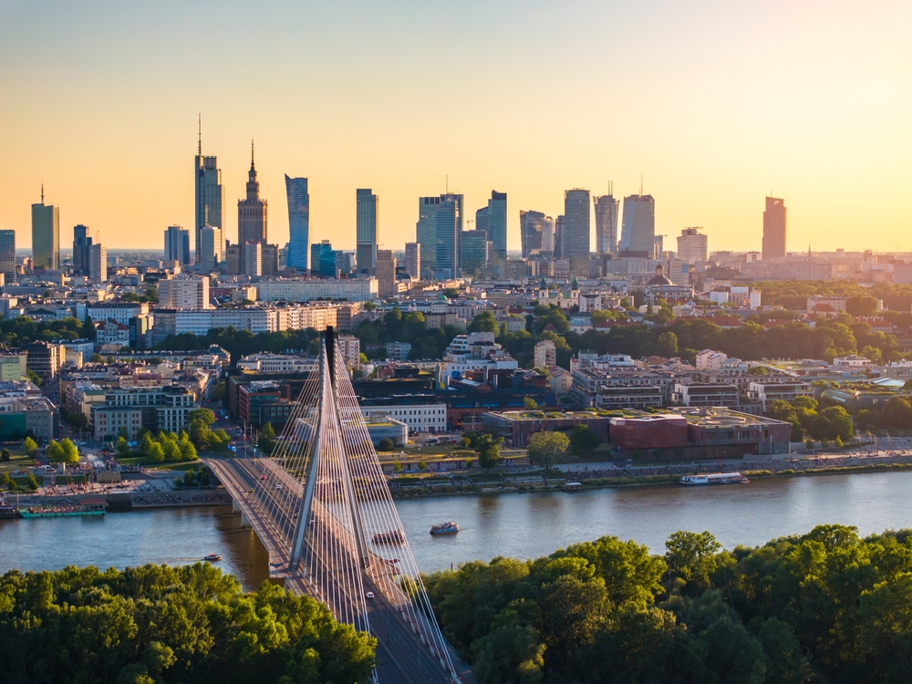 Warsaw skyline at sunset seen across the Vistula