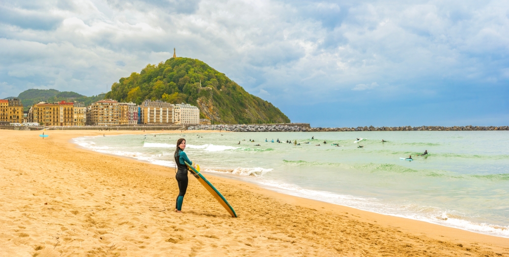 Surfer on Zurriola beach in Gros, San Sebastian