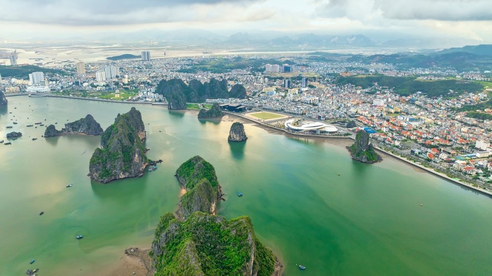 Aerial view of Ha Long town and the limestone islands of Ha Long Bay