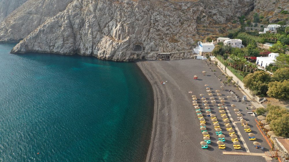 Aerial view of Kamari town and beach with sunbeds
