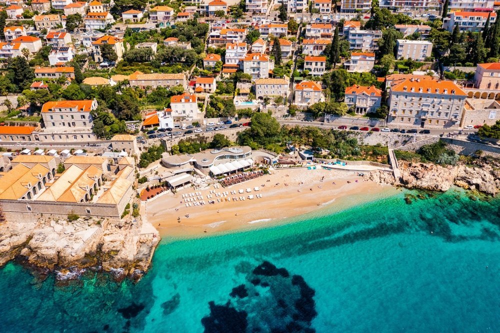 Banje Beach in Dubrovnik with the Old Town and the city walls in the background