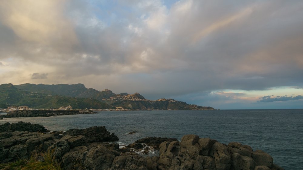 The bay at Giardini Naxos looking towards Capo Taormina at sunset