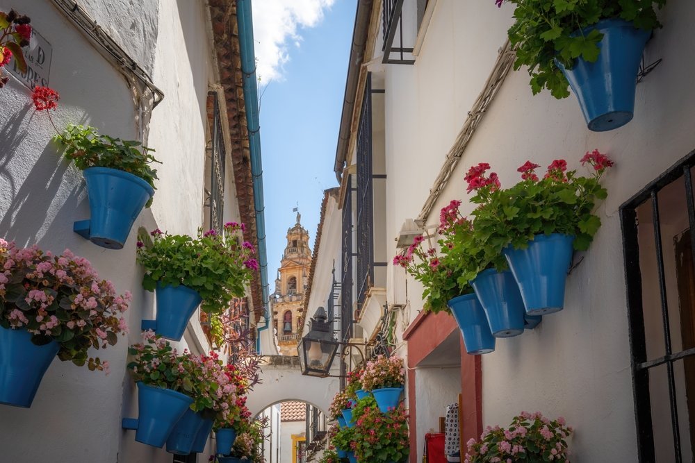 Calleja de las Flores in the Judería in Córdoba with the Mezquita bell tower in the background