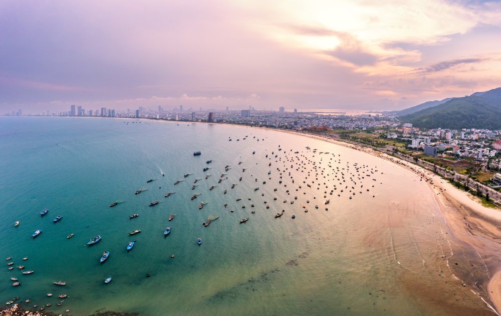 Fishing boats on My Khe Beach in Da Nang at sunrise
