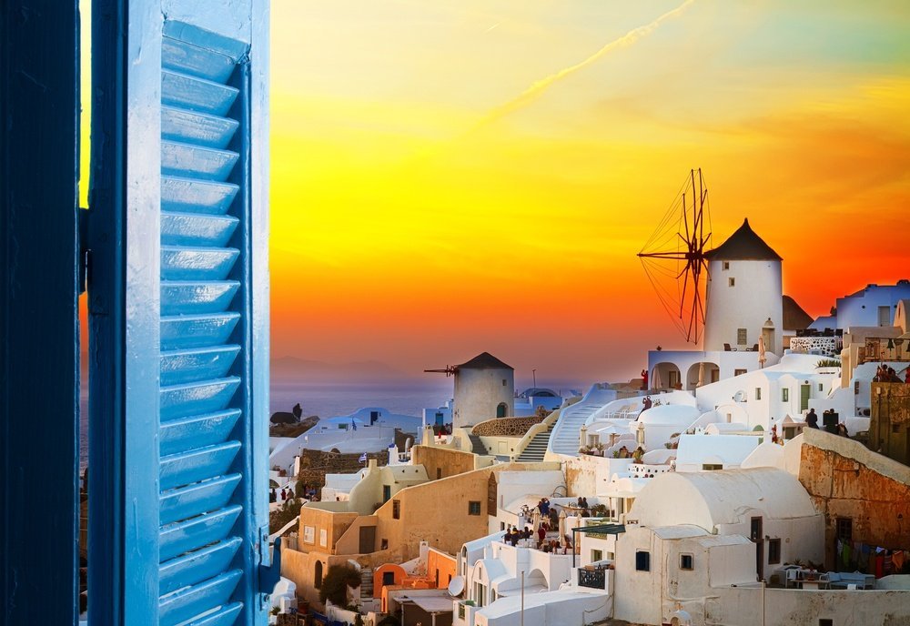 golden sunset in Oia with a windmill