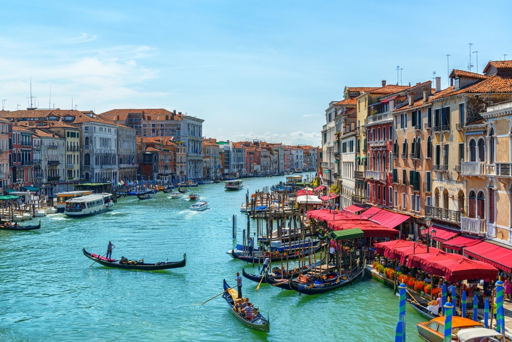 The Grand Canal in Venice with gondolas and water buses seen from the Rialto Bridge