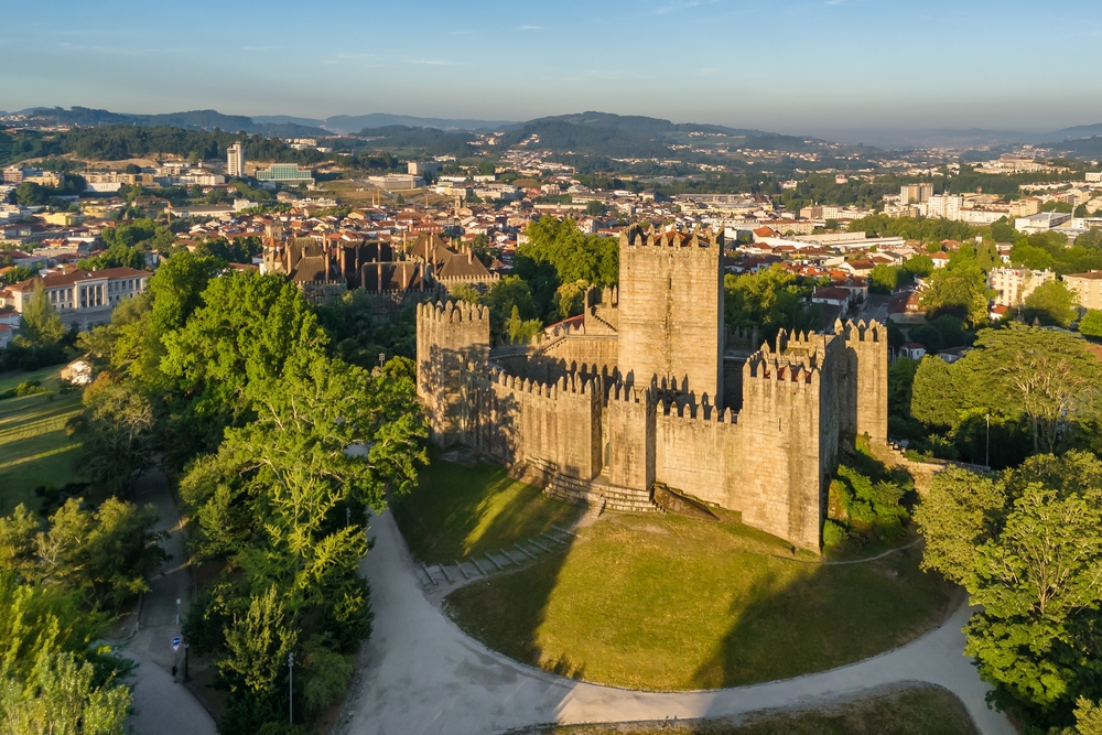 17 Best Things to Do in Porto: Sights, Prices & Tips 18 Aerial photo of the castle in Guimarães at sunrise