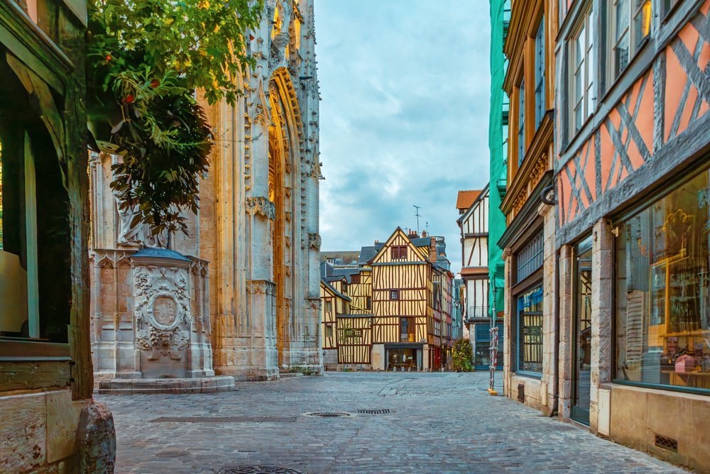 Half-timbered houses in Rouen's Old Town with Notre-Dame Cathedral at the end of the street