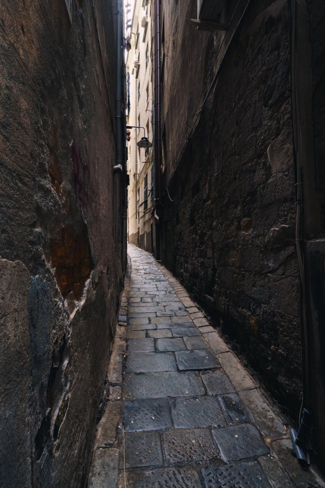 Narrow alley between tall buildings in Centro Storico in Genoa