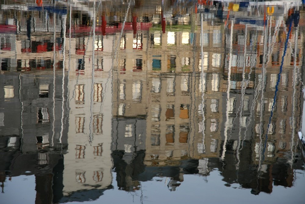 The narrow houses around the old harbour, Vieux Bassin, in Honfleur reflected in the water