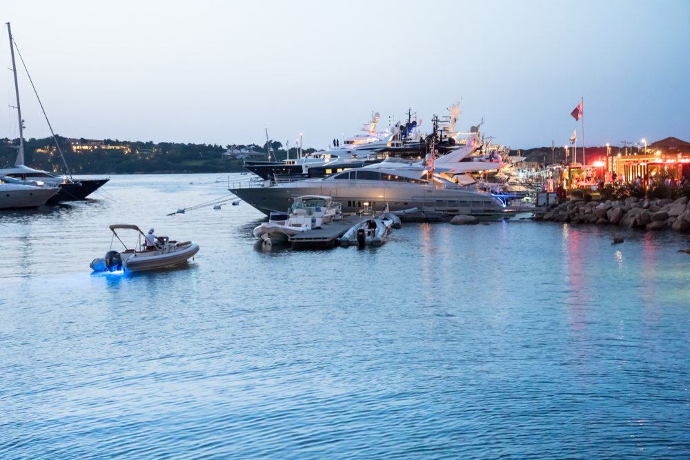 Olbia, Cagliari & Alghero Airport to Town & Your Hotel - Transport Guide 5 Luxury yachts in the marina at Porto Cervo on the Costa Smeralda in the evening