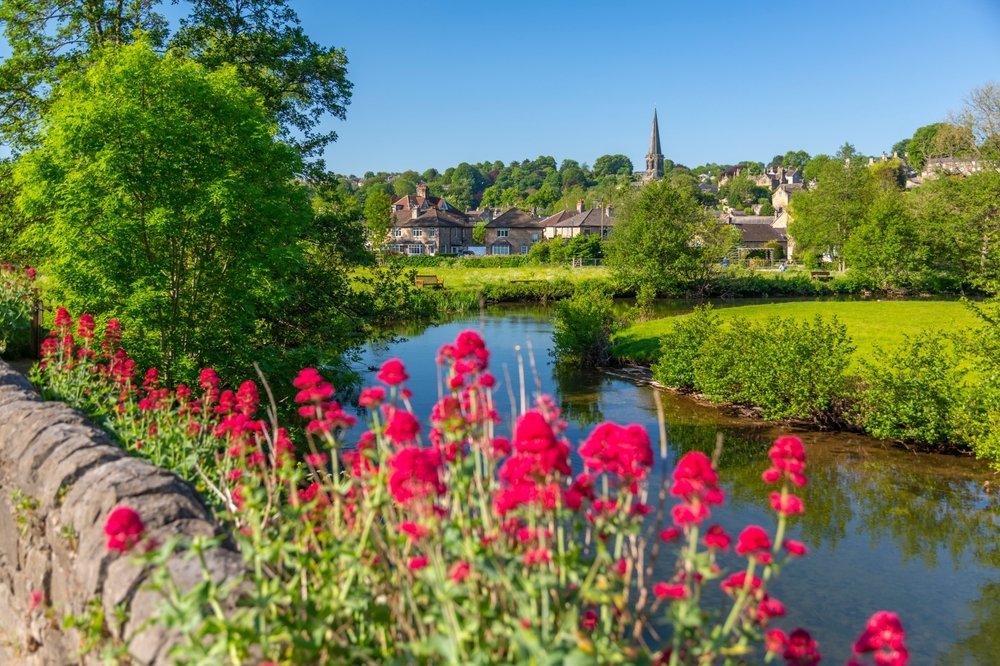 The River Wye flowing through Bakewell with All Saints' Church on the hill