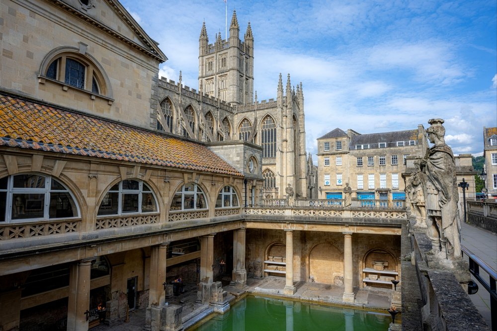 The Roman Baths in the centre of Bath with Bath Abbey behind