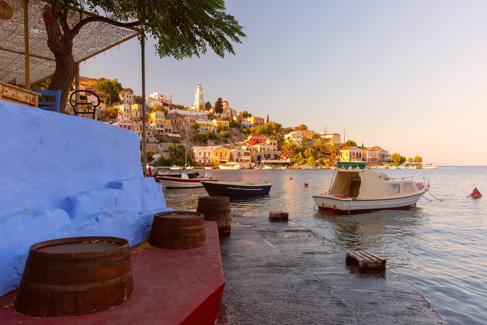 Colourful houses and boats in the harbour on Symi