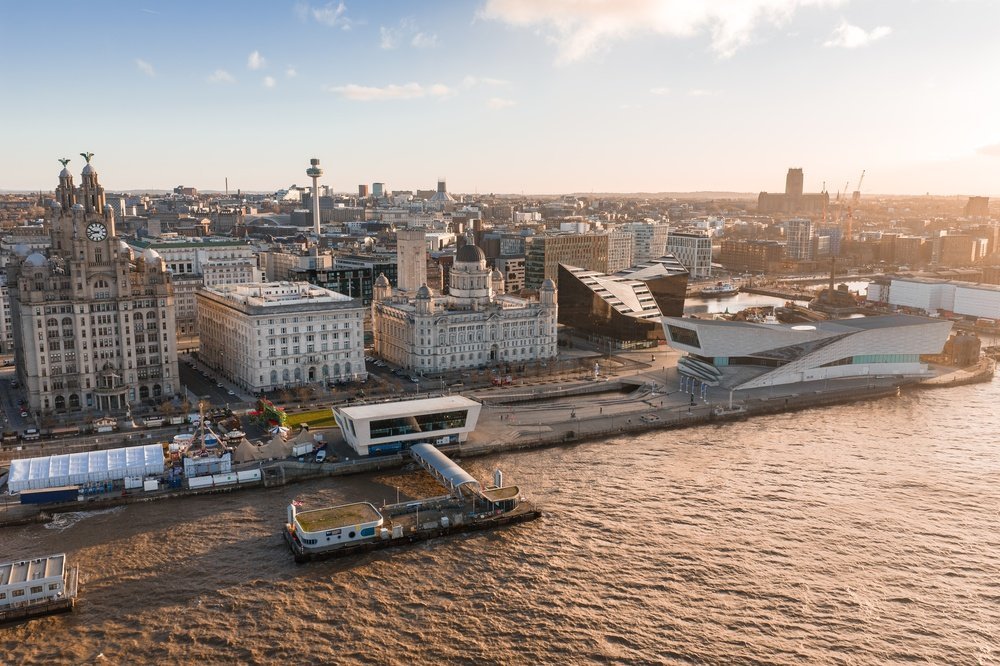 Aerial view of Liverpool's waterfront with the Three Graces and the cathedral at sunrise