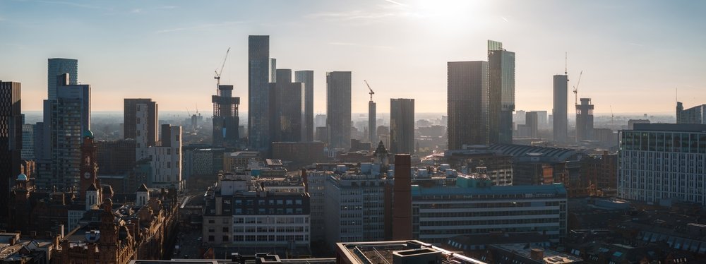 Aerial view of Manchester city centre with skyscrapers and red brick buildings
