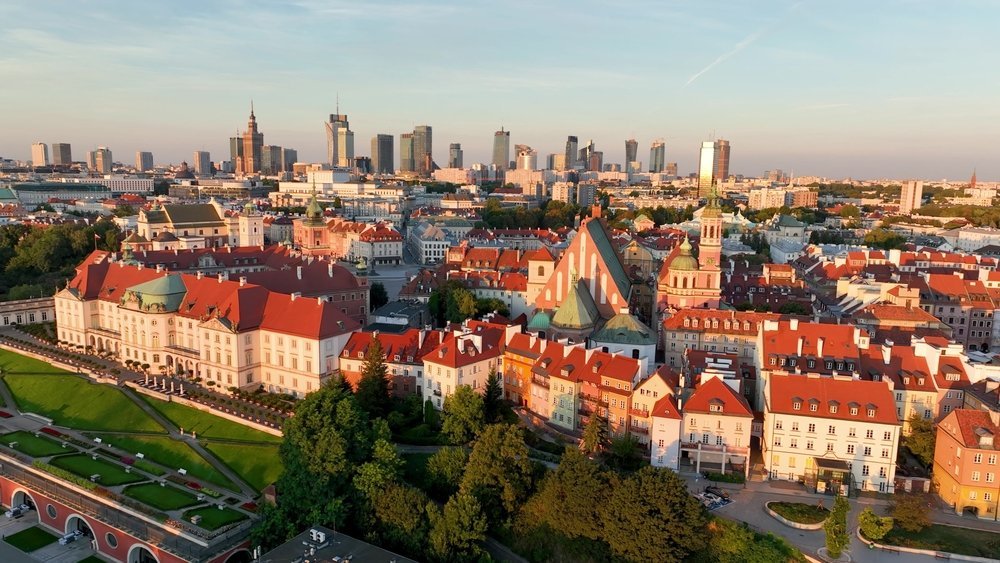 Aerial view of Warsaw's Old Town and the Royal Castle, with the skyscrapers of the city centre behind