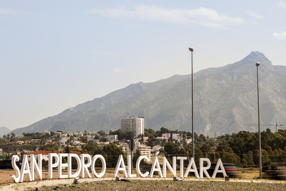 The town sign at the entrance to San Pedro de Alcántara with La Concha mountain