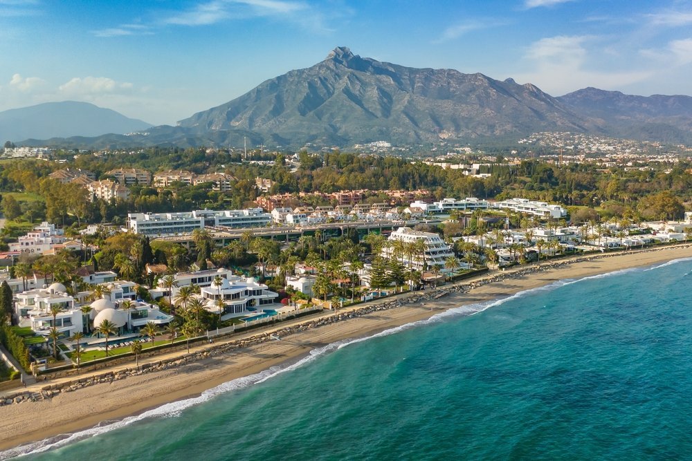 Villas and hotels by the beach on the Golden Mile in Marbella with La Concha mountain