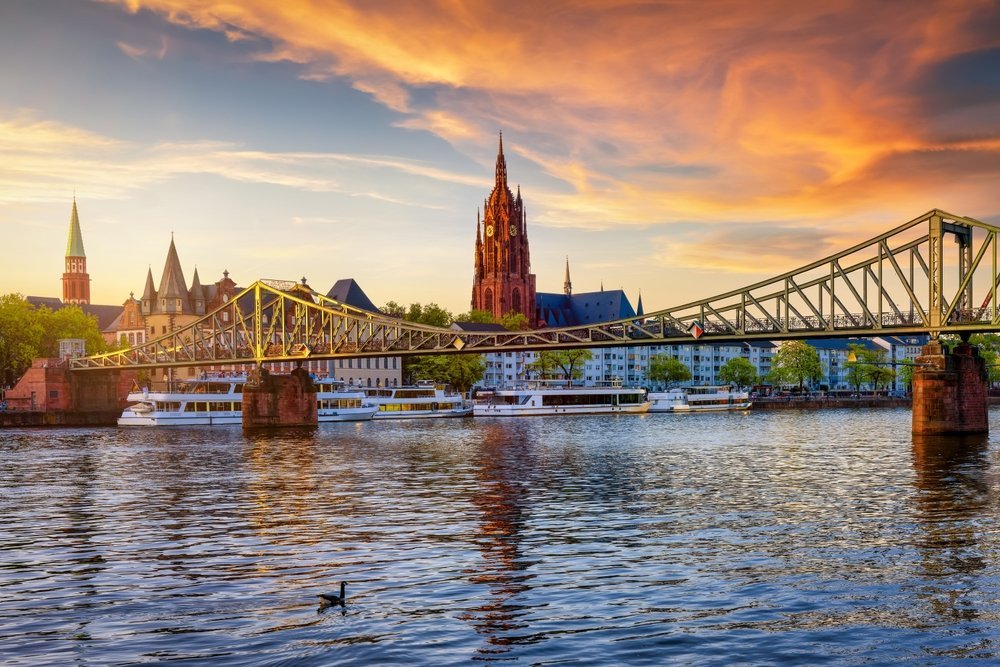 Frankfurt skyline with the Eiserner Steg footbridge and the Kaiserdom over the River Main at sunset