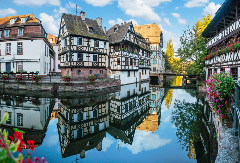 Half-timbered houses in Petite France reflected in the canals in Strasbourg