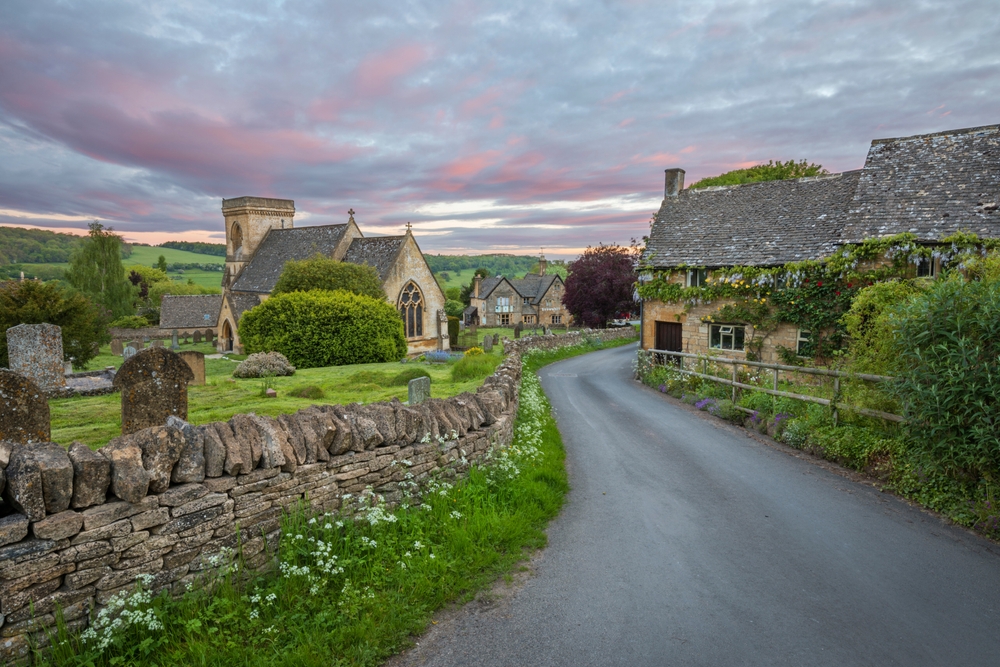 Stone houses and St Barnabas Church in the village of Snowshill in the Cotswolds